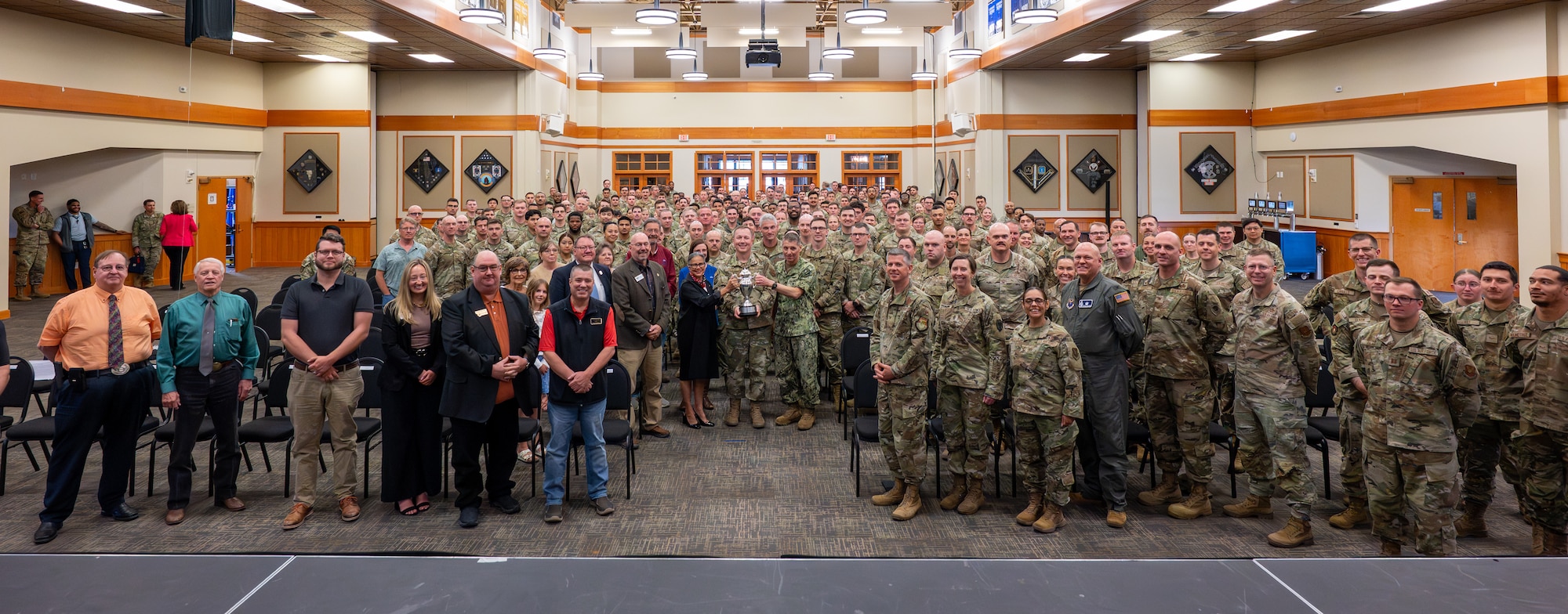 U.S. Navy Adm. Rich Correll, commander of U.S. Strategic Command, center right, and Nebraska State Sen. Rita Sanders, a member of the Strategic Command Consultation Committee (SCCC), center left, and U.S. Air Force Col. Daniel Voorhies, 341st Missile Wing commander, pose with 341st Missile Wing Airmen, civic leaders, and the 2025 Omaha Trophy at Malmstrom Air Force Base, Montana, June 18, 2026. Earning the Omaha Trophy underscores the wing's central missions, its emphasis on strategic deterrence, and its evolving role in global operations. (U.S. Air Force Photo by Tech. Sgt. Aaron Thomasson)