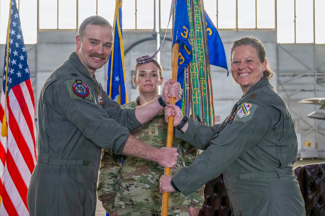 U.S. Air Force Maj. Nikki Yogi, right, assumes command of the 353rd Combat Training Squadron from U.S. Air Force Col. Samuel Chipman, 354th Operations Group commander, during a change of command ceremony at Eielson Air Force Base, Alaska, June 26, 2026.