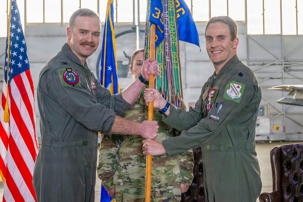 U.S. Air Force Lt. Col. Eric Hakos, right, relinquishes command of the 353rd Combat Training Squadron to U.S. Air Force Col. Samuel Chipman, 354th Operations Group commander, during a change of command ceremony at Eielson Air Force Base, Alaska, June 26, 2026.