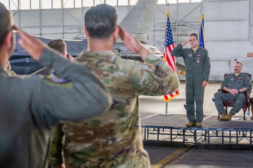 U.S. Lt. Col. Eric Hakos, 353rd Combat Training Squadron commander, renders his final salute to members of the 353rd CTS during a change of command ceremony at Eielson Air Force Base, Alaska, June 26, 2026.