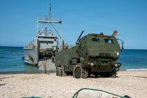 U.S. Marines with 3rd Littoral Combat Team, 3rd Marine Littoral Regiment, 3rd Marine Division, and U.S. Army Soldiers with 7th Infantry Division, Multi-Domain Command - Pacific, guide an M142 High Mobility Artillery Rocket System off a U.S. Army Landing Craft Utility during a ship-to-shore movement for Exercise Balikatan 2026 at Calayan, Cagayan, Philippines, April 28, 2026.