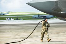 U.S. Army Reserve Sgt. Soonafai Seloti, Forward Support Company 411th Engineer Battalion, 303rd Maneuver Enhancement Brigade, 9th Mission Support Command, prepares to connect the fuel hose of a U.S. Army Heavy Expanded Mobility Tactical Truck to refuel a U.S. Air Force F-35 Lightning II, 4th Expeditionary Fighter Squadron, June 22, 2026, at Anderson Air Force Base, Guam, as part of exercise Valiant Shield 2026 (VS26).