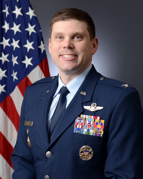 Col. Adam Boyd official photo with American flag in the background