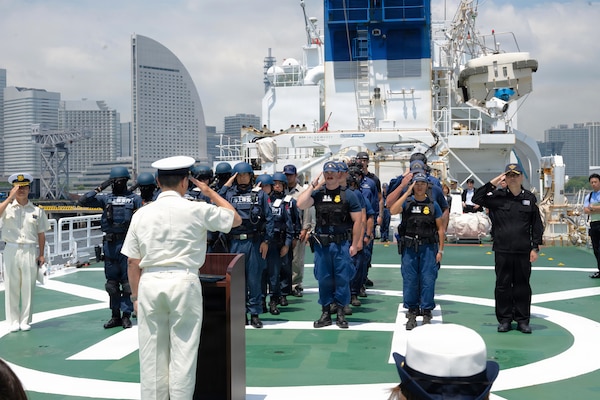 U.S. Coast Guard maritime enforcement specialists assigned to Legend-class cutter USCGC Midgett (WMSL 757) stand and salute with members of the Japan Coast Guard law enforcement teams on the flight deck of Japan Coast Guard patrol vessel JCGS Buko (PL-10) after completing a law enforcement demonstration for Japan Coast Guard official; members of Legend-class cutter USCGC Midgett (WMSL 757) command staff; U.S. Coast Guard Vice Adm. Joseph Buzzella, commander, Pacific Area; during a law enforcement tactics demonstration during Pacific Atlas in Yokohama, Japan, June 19, 2026.
