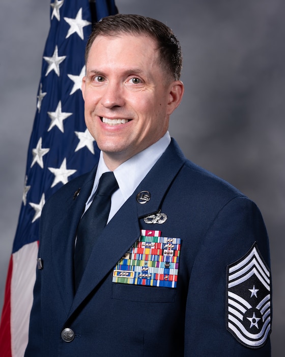 CMSgt Matthew DiNunzio official photo with American flag in the background