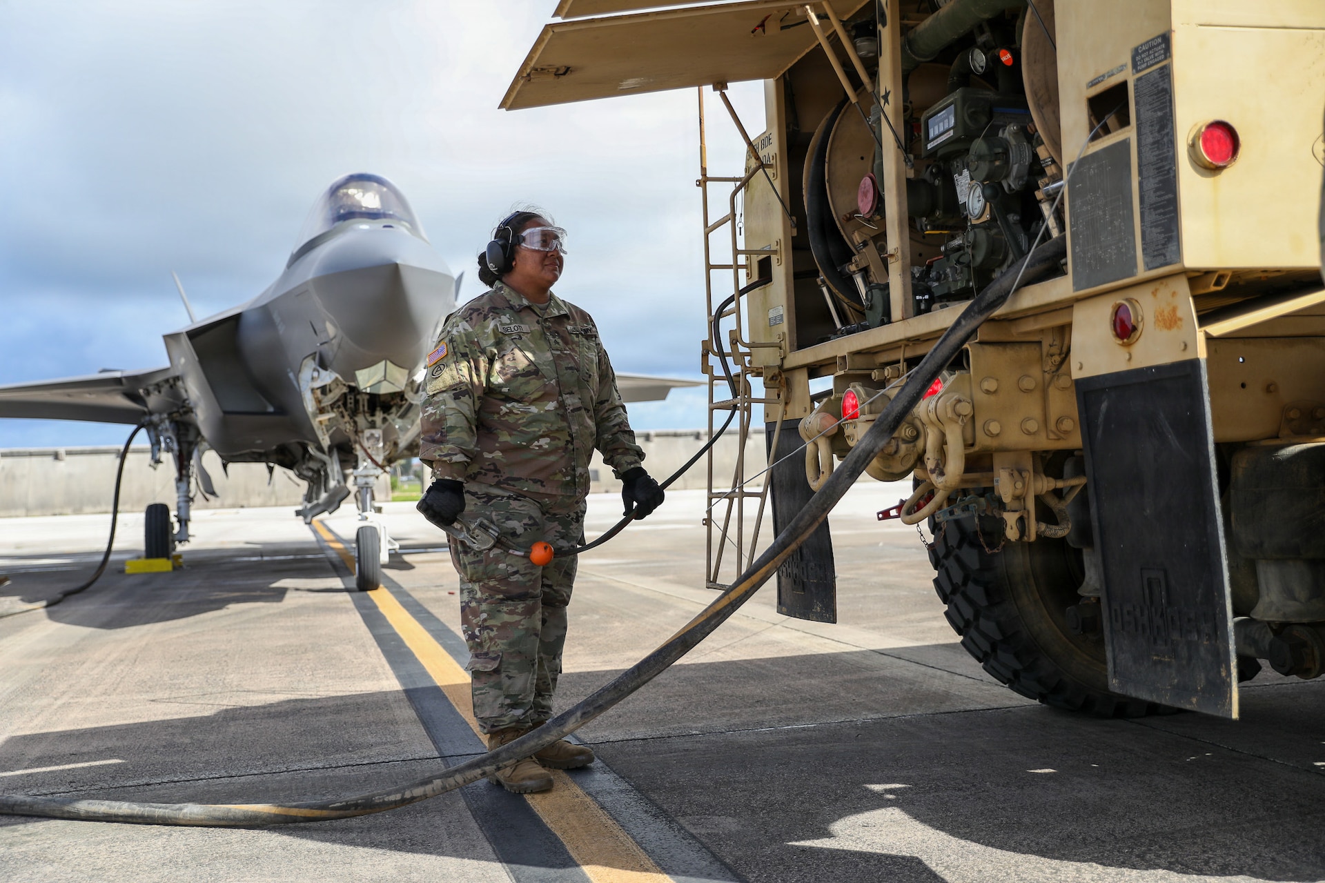 U.S. Army Reserve Sgt. Soonafai Seloti, assigned to the Forward Support Company, 411th Engineer Battalion, 303rd Maneuver Enhancement Brigade, 9th Mission Support Command, prepares to begin refueling a U.S. Air Force F-35 Lightning II assigned to the 4th Expeditionary Fighter Squadron using a U.S. Army Heavy Expanded Mobility Tactical Truck during Exercise Valiant Shield 2026 at Andersen Air Force Base, Guam, June 22, 2026.