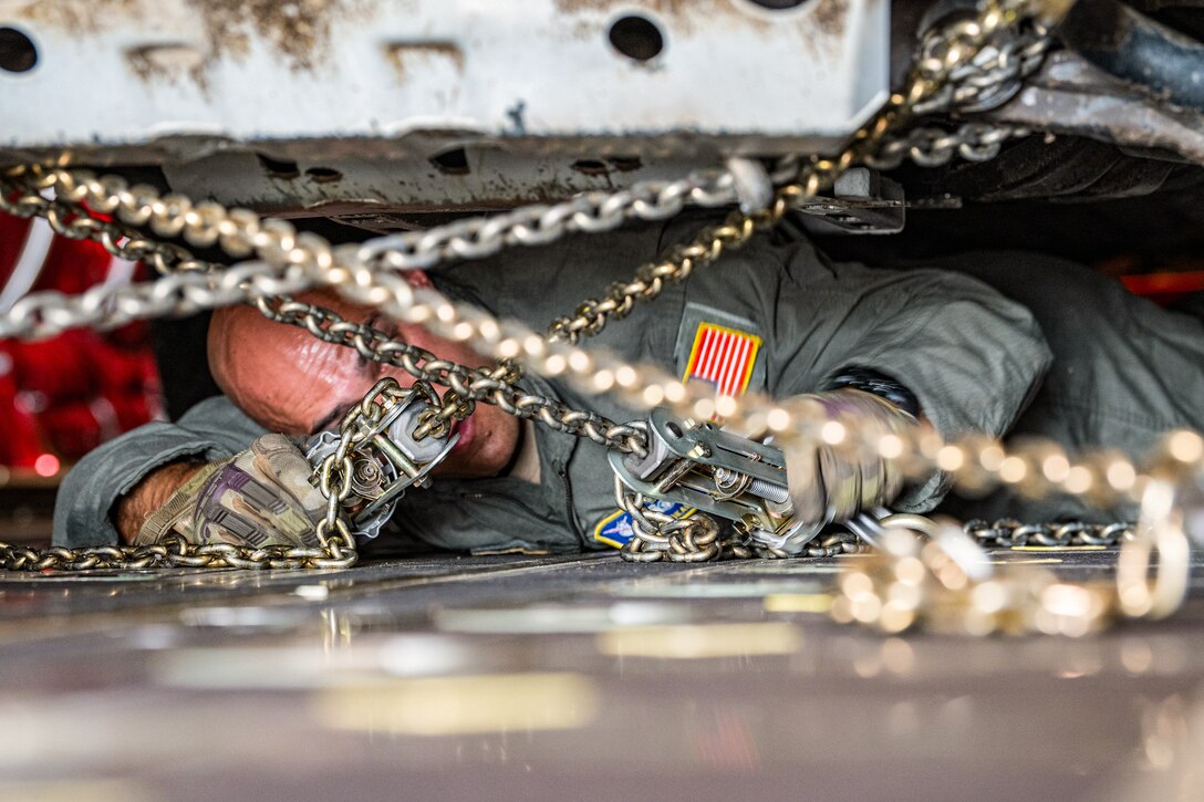 U.S. Air Force Tech. Sgt. Eric Skaggs, a loadmaster assigned to the 123rd Airlift Wing, Kentucky Air National Guard, chains a vehicle to the cargo bay of a C-130J Super Hercules aircraft at Esbjerg Airport, Denmark, during exercise Ramstein Flag on June 18, 2026. The 123rd AW is providing tactical airlift to NATO Allies throughout the month of June for the Allied Air Command event, a large-scale, multi-location and joint operating area exercise with 18 participating nations and more than 200 aircraft. (U.S. Air National Guard photo by Senior Airman Annaliese Billings)