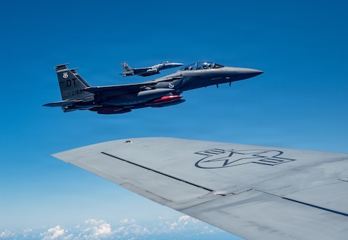 A U.S. Air Force F-15EX Eagle II and F-15E Strike Eagle assigned to the 85th Test and Evaluation Squadron, Eglin Air Force Base, Florida, fly in formation on the wing of a KC-135 Stratotanker assigned to the 909th Air Refueling Squadron over the Pacific Ocean, June 29, 2026.