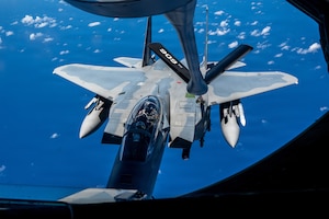 A U.S. Air Force F-15EX Eagle II assigned to the 85th Test and Evaluation Squadron, Eglin Air Force Base, Florida, approaches a KC-135 Stratotanker assigned to the 909th Air Refueling Squadron for aerial refueling en route to Kadena Air Base, Japan, June 29, 2026