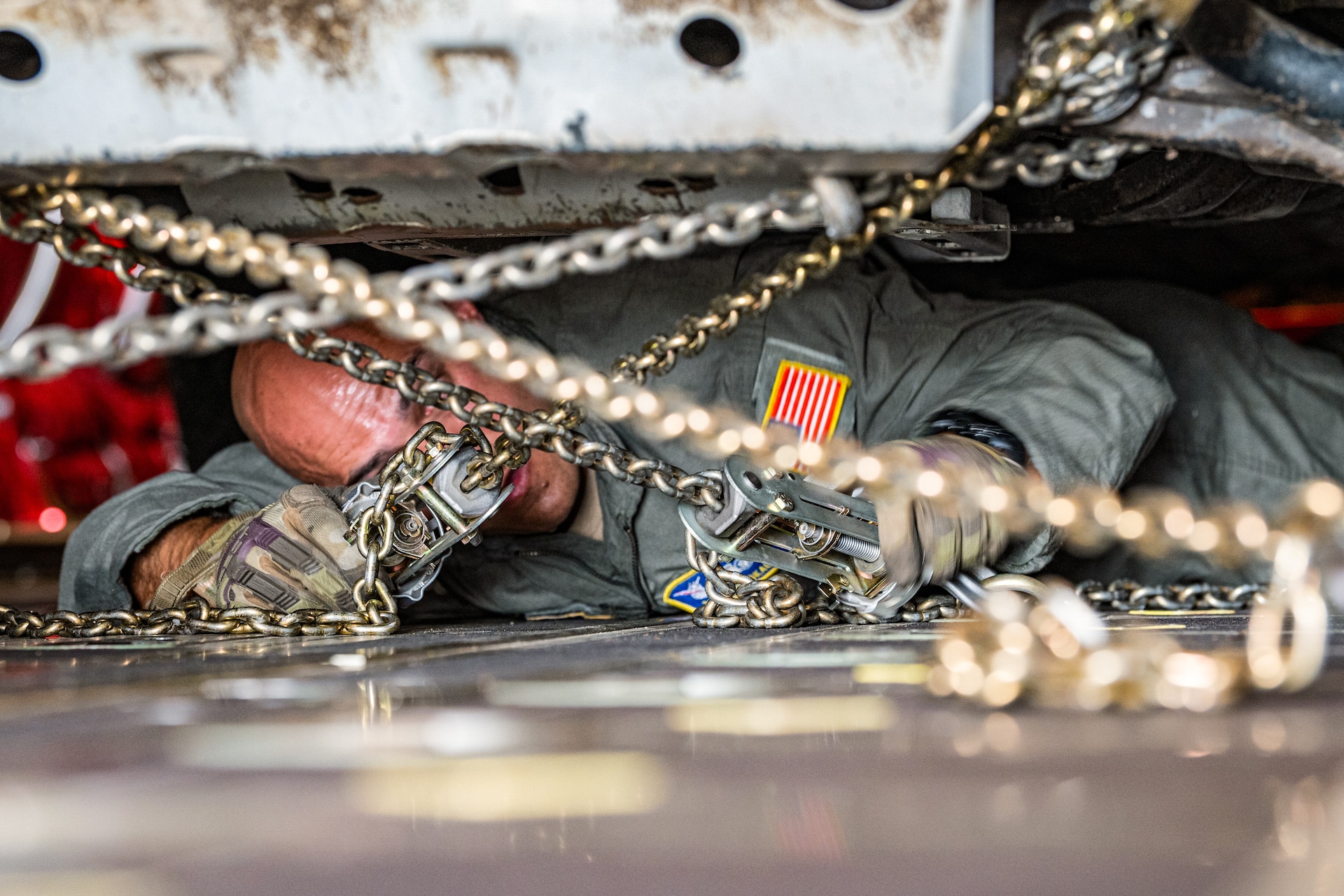U.S. Air Force Tech. Sgt. Eric Skaggs, a loadmaster assigned to the 123rd Airlift Wing, Kentucky Air National Guard, chains a vehicle to the cargo bay of a C-130J Super Hercules aircraft at Esbjerg Airport, Denmark, during exercise Ramstein Flag on June 18, 2026. The 123rd AW is providing tactical airlift to NATO Allies throughout the month of June for the Allied Air Command event, a large-scale, multi-location and joint operating area exercise with 18 participating nations and more than 200 aircraft. (U.S. Air National Guard photo by Senior Airman Annaliese Billings)
