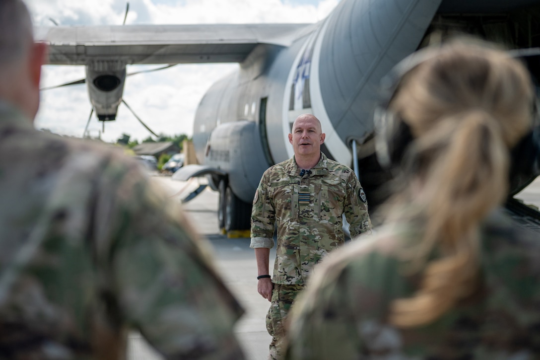 The commander of a Danish Armed Forces Air Mobile Protection and Recovery Flight discusses his unit’s mission in front of a U.S. Air Force C-130J Super Hercules aircraft assigned to the 123rd Airlift Wing, Kentucky National Guard, at Karup Air Base, Denmark, June 18, 2026. Concurrent with Ramstein Flag 2026, the Air National Guard is conducting bilateral training with Danish defense forces, enhancing interoperability and showcasing a unified dedication to deterrence and global peace through strength. (U.S. Air National Guard photo by Senior Airman Annaliese Billings)