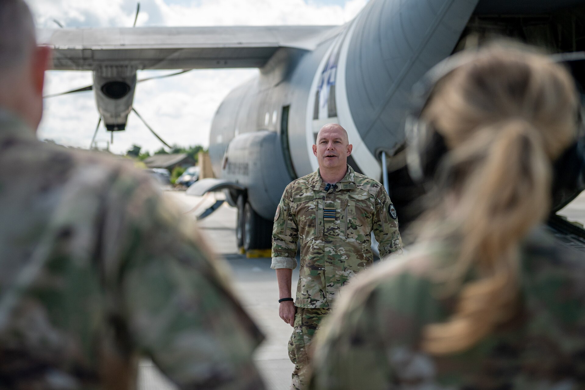 The commander of a Danish Armed Forces Air Mobile Protection and Recovery Flight discusses his unit’s mission in front of a U.S. Air Force C-130J Super Hercules aircraft assigned to the 123rd Airlift Wing, Kentucky National Guard, at Karup Air Base, Denmark, June 18, 2026. Concurrent with Ramstein Flag 2026, the Air National Guard is conducting bilateral training with Danish defense forces, enhancing interoperability and showcasing a unified dedication to deterrence and global peace through strength. (U.S. Air National Guard photo by Senior Airman Annaliese Billings)