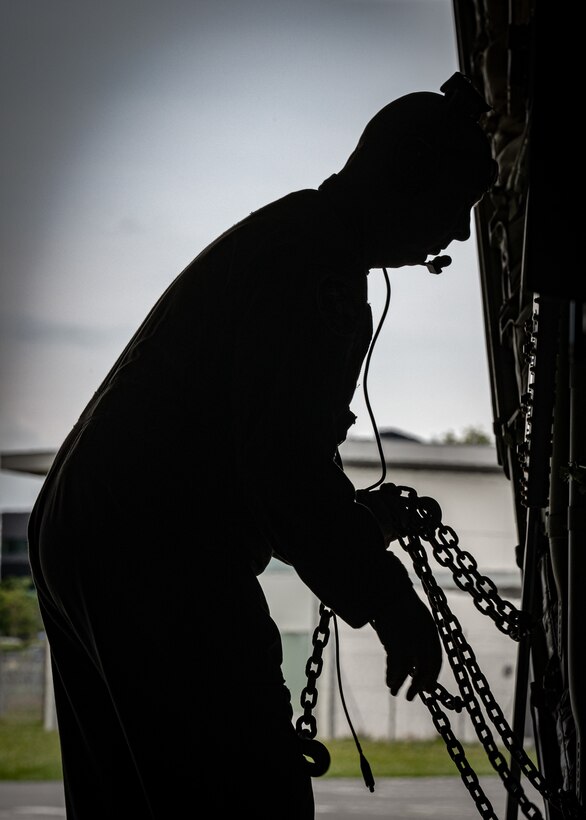 U.S. Air Force Tech. Sgt. Wes Jones, a loadmaster assigned to the 123rd Airlift Wing, Kentucky Air National Guard, grabs chains to secure cargo on a C-130J Super Hercules at Esbjerg Airport,  Denmark, during exercise Ramstein Flag on June 18, 2026. The 123rd AW is providing tactical airlift to NATO Allies throughout the month of June for the Allied Air Command event, a large-scale, multi-location and joint operating area exercise with 18 participating nations and more than 200 aircraft. (U.S. Air National Guard photo by Senior Airman Annaliese Billings)