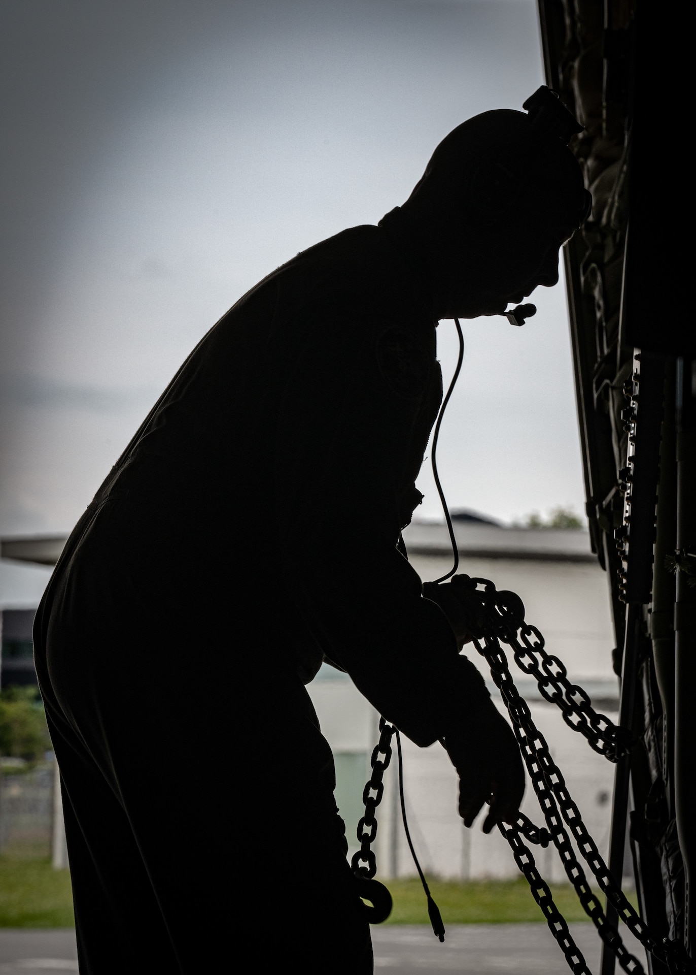 U.S. Air Force Tech. Sgt. Wes Jones, a loadmaster assigned to the 123rd Airlift Wing, Kentucky Air National Guard, grabs chains to secure cargo on a C-130J Super Hercules at Esbjerg Airport,  Denmark, during exercise Ramstein Flag on June 18, 2026. The 123rd AW is providing tactical airlift to NATO Allies throughout the month of June for the Allied Air Command event, a large-scale, multi-location and joint operating area exercise with 18 participating nations and more than 200 aircraft. (U.S. Air National Guard photo by Senior Airman Annaliese Billings)