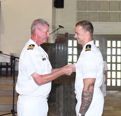 260630-N-JB216-2578 Jacksonville, Fla. (June 30, 2026) Capt. Craig Malloy, Naval Hospital (NH) Jacksonville’s director, pins Lt. Gabriel Meriwether, an intern graduate during the NH Jacksonville Family Medicine Residency Program graduation at All Saints Chapel aboard Naval Air Station Jacksonville on June 30. Twenty-nine physicians are the latest graduates of this award-winning program, which is currently celebrating its 56th year of continuous accreditation. (U.S. Navy photo by Kie Savage, Naval Hospital Jacksonville/Released).