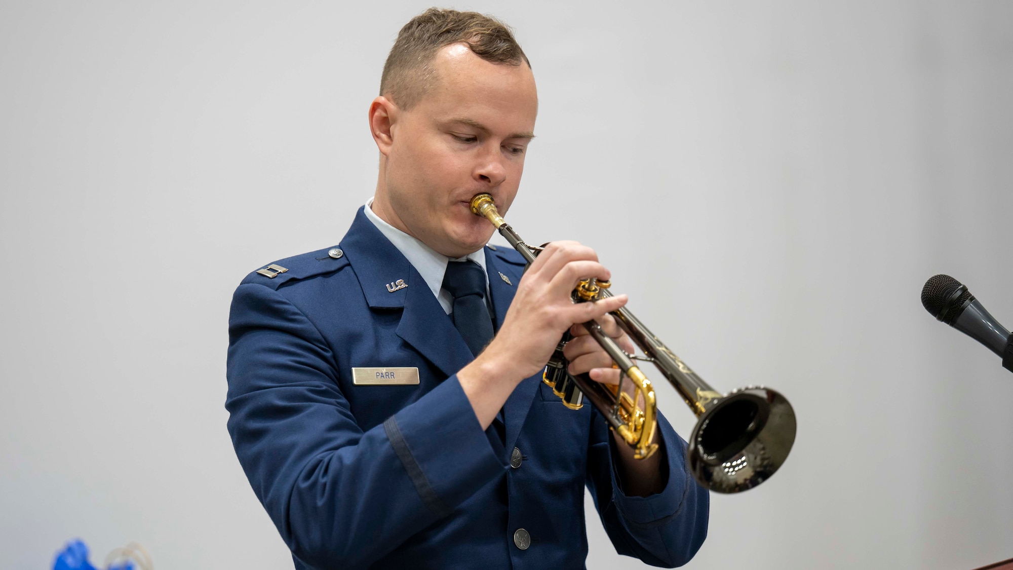 Capt. Michael Parr plays the trumpet during GXF’s change of command ceremony.