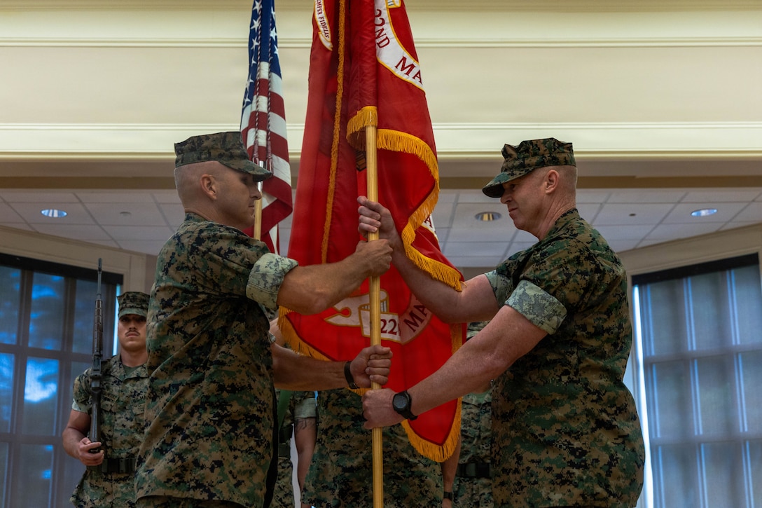 U.S. Marine Corps Col. Tom “Banshee” Trimble, right, outgoing commanding officer, hands the organizational colors to Col. Jeremy Hawkins, left, oncoming commanding officer of the 22nd Marine Expeditionary Unit, during the 22nd MEU change of command ceremony Marine Corps Base Camp Lejeune, North Carolina, June 29, 2026. The ceremony signified the transfer of authority, accountability and leadership from Col. Tom Trimble, the off-going commanding officer of 22nd MEU, to Col. Jeremy Hawkins. (U.S. Marine Corps photo by Sgt. Tanner Bernat)