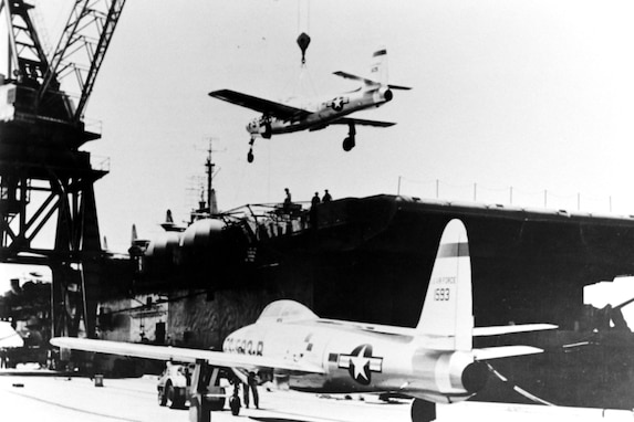 USS SITKOH BAY, August 16, 1951 - A F-84 Thunderjet of the Georgia Air National Guard’s 116th Fighter Bomber Wing is lifted onto the deck of the Escort Carrier Sitkoh Bay preparatory to sailing to Japan to assist in the United Nations’ air war against communist forces in Korea.