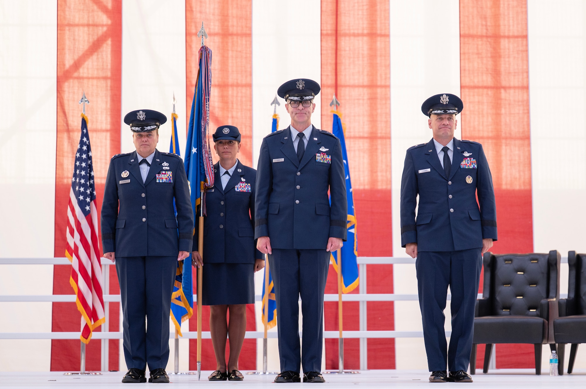 Maj. Gen. Scott Cain (center), Air Force Test Center commander, prepares to relinquish command at the Air force Test Center change of command ceremony at Edwards Air Force Base, California, June 30, 2026.  The Air Force Test Center provides developmental test and evaluation of experimental and research, manned and unmanned air, space and cyber systems for the military services, Defense Advanced Research Projects Agency, National Aeronautics and Space Administration and international partners, in addition to operating the U.S. Air Force Test Pilot School. (U.S. Air Force photo by Tech. Sgt. Robert Cloys)