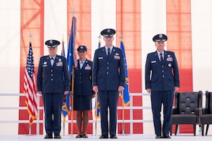 Maj. Gen. Scott Cain (center), Air Force Test Center commander, prepares to relinquish command at the Air force Test Center change of command ceremony at Edwards Air Force Base, California, June 30, 2026.  The Air Force Test Center provides developmental test and evaluation of experimental and research, manned and unmanned air, space and cyber systems for the military services, Defense Advanced Research Projects Agency, National Aeronautics and Space Administration and international partners, in addition to operating the U.S. Air Force Test Pilot School. (U.S. Air Force photo by Tech. Sgt. Robert Cloys)