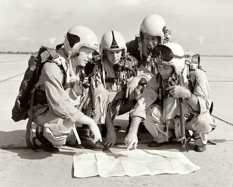Four pilots of the 116th Fighter-Bomber Wing, Georgia Air National Guard, study a course for their F-51 Mustangs during annual training at Travis Field, Savannah, Ga. Left to right: Lt. William Tennent, Lt. George B. Dunbar, Lt. John E. Hayes and Capt. Charles H. Allen.