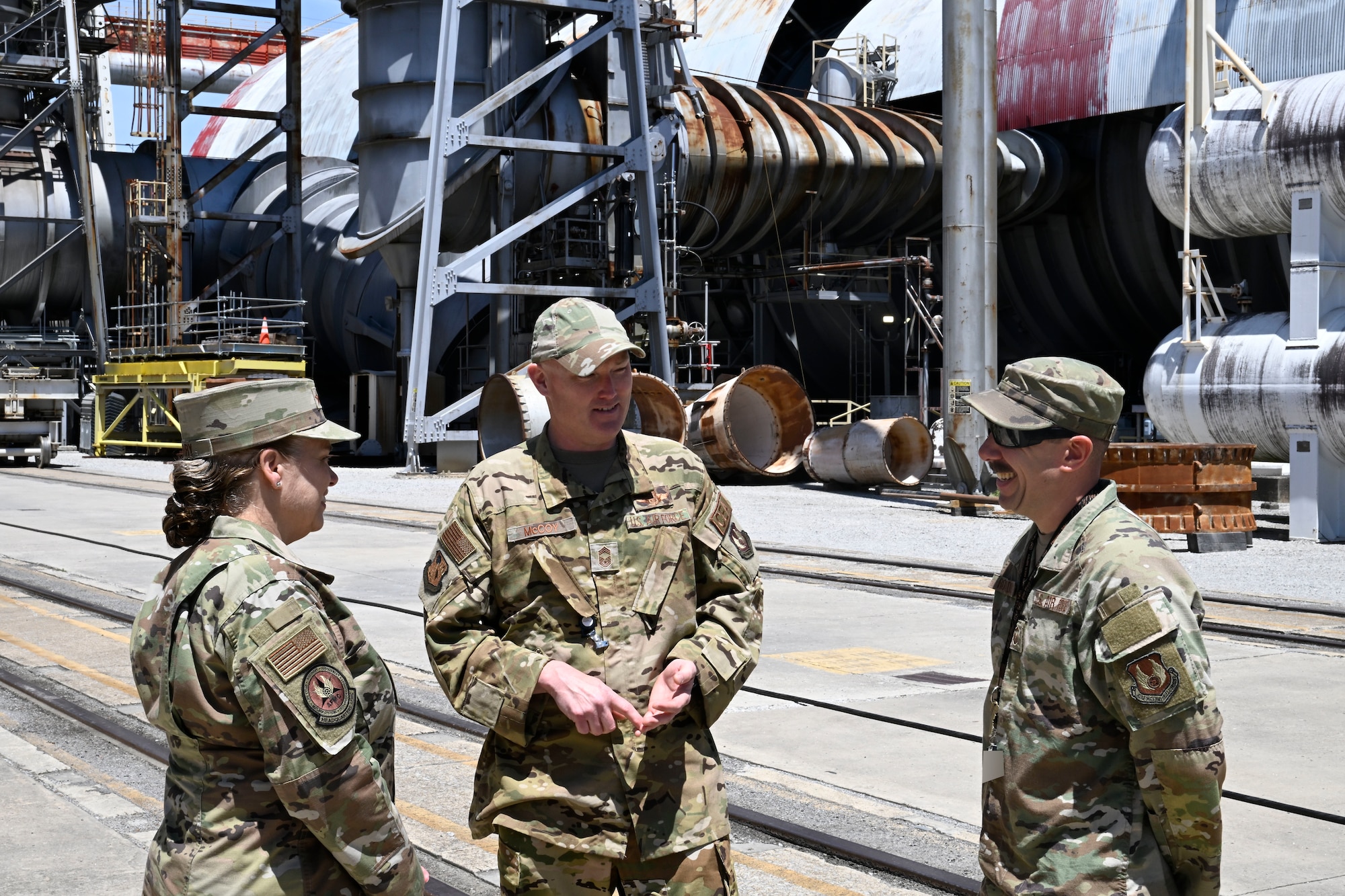 Lt. Gen. Linda Hurry, commander of Air Force Materiel Command, listens as Chief Master Sgt. Evan McCoy, Arnold Engineering Development Complex senior enlisted leader, center, discusses the accomplishments of Master Sgt. Gregg Rosado, aerospace propulsion specialist, during a May 15, 2026, visit to Arnold AFB, Tenn. Arnold AFB is the headquarters of AEDC, a unit of the Air Force Test Center, which is a unit of AFMC. (U.S. Air Force photo by Brad Hicks) (This image was altered by obscuring badges for security purposes)