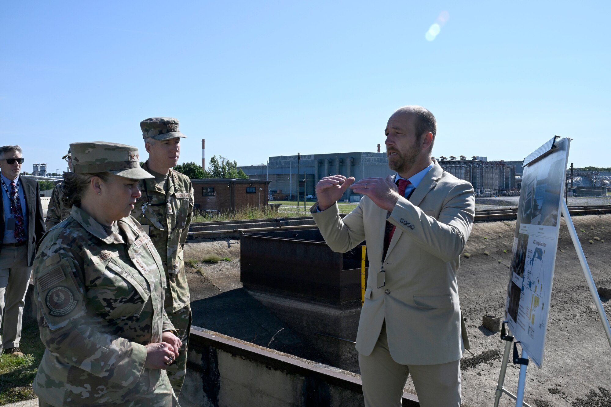 Lt. Gen. Linda Hurry, commander of Air Force Materiel Command, listens as Joshua Cooke, Senior Utility Manager at Arnold Air Force Base, right, discusses the Secondary Reservoir at Arnold AFB. Hurry toured Arnold AFB, Tenn., May 15, 2026. Arnold AFB is the headquarters of Arnold Engineering Development Complex, a unit of AFMC. Also pictured is Col. Grant Mizell, AEDC commander, center. (U.S. Air Force photo by Brad Hicks) (This image has been altered by obscuring badges for security purposes)