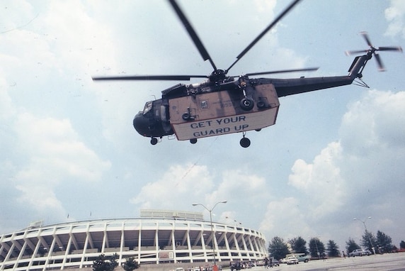 ATLANTA, 1977 - A CH-54 Skycrane of the 1160th Transportation Company (Heavy Helicopter) lifts a crew pod over Atlanta Fulton-County Stadium as part of the "Get Your Guard Up" recruiting campaign which ran from July to September 1977. Image courtesy of the Georgia Guard Archives.