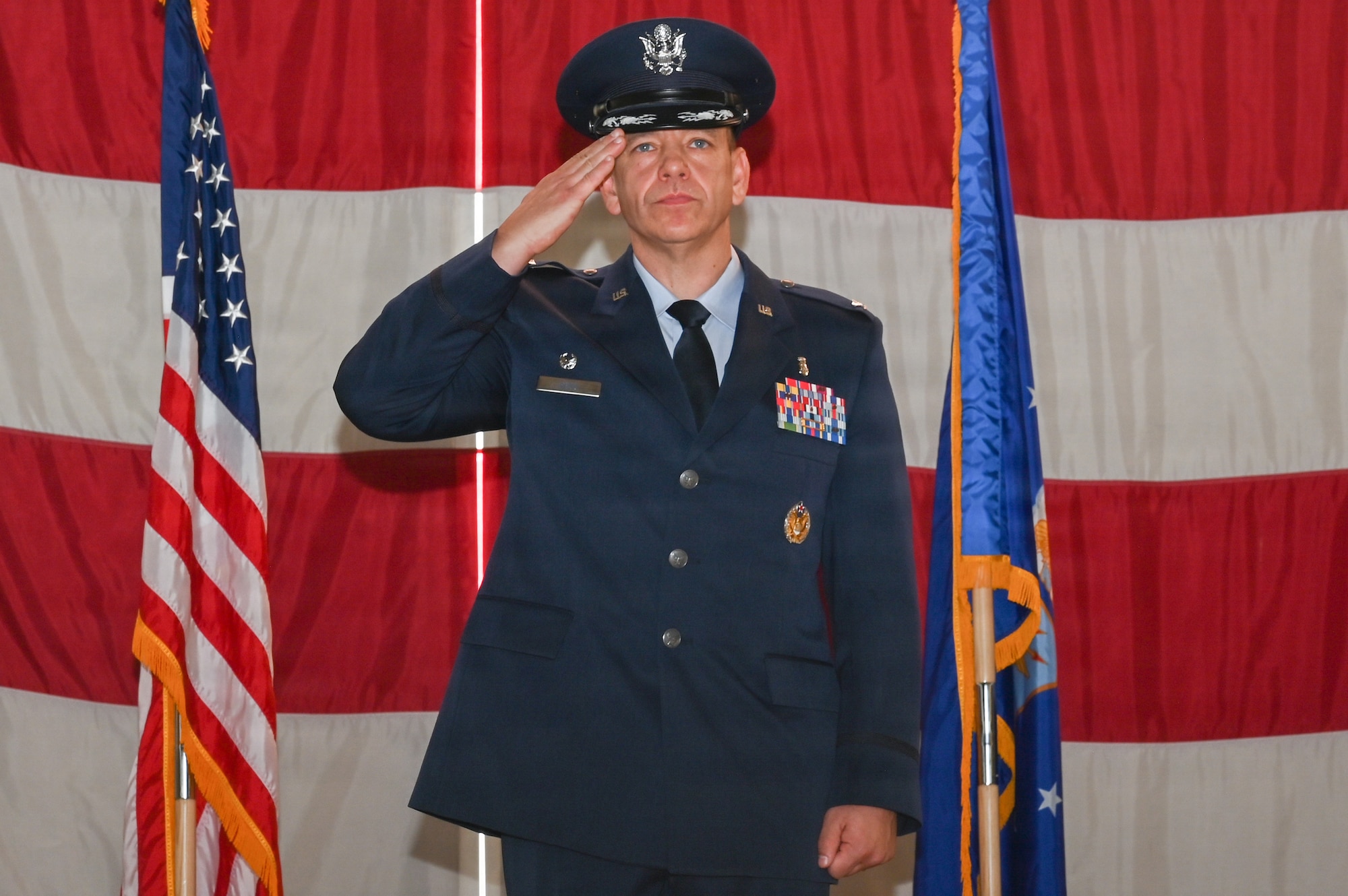 U.S. Air Force Col. Cody J. Hess, incoming Kirtland Medical Group commander, renders his first salute at the Kirtland Medical Group change of command ceremony at Kirtland Air Force Base.
