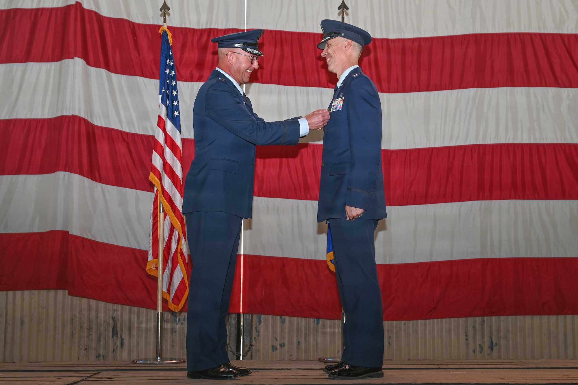 U.S. Air Force Col. Justin D. Secrest, 377th Air Base Wing and installation commander, pins the Legion of Merit award on Col. Steven M. Fox, outgoing Kirtland Medical Group commander, at the Kirtland Medical Group change of command ceremony at Kirtland Air Force Base