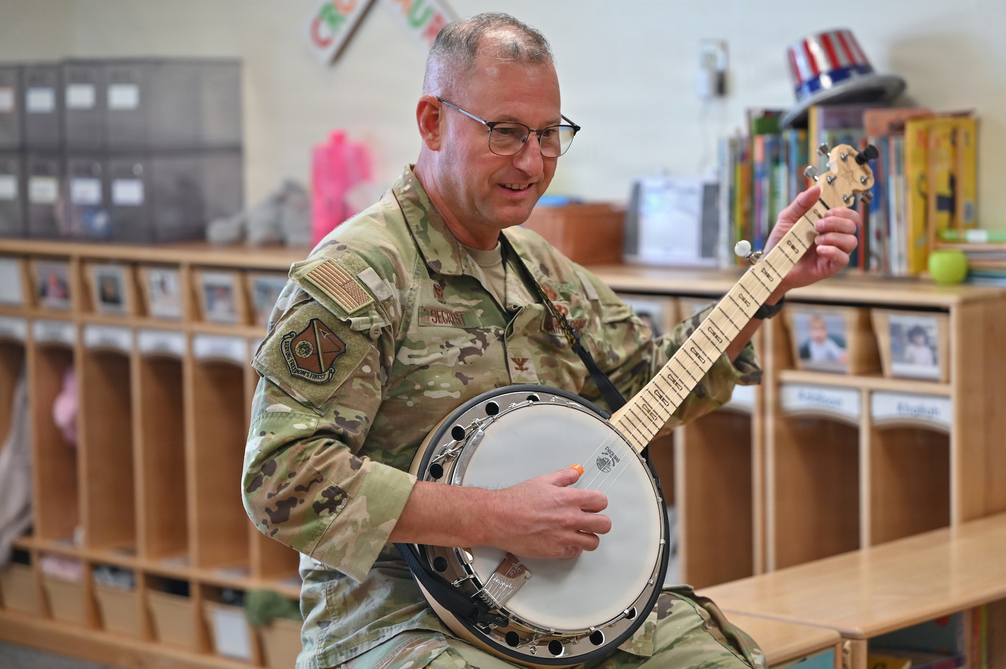 U.S. Air Force Col. Justin D. Secrest, 377 Air Base Wing and installation commander, showcases his banjo skills for children at the Maxwell Child Development Center at Kirtland Air Force Base.