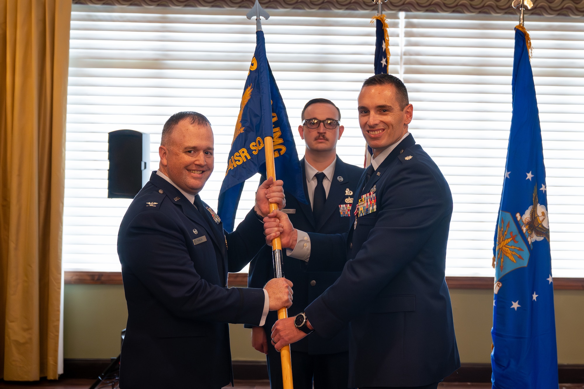 Lt. Col. Joshua Clayton Integrated Command, Control, Communications, Computers, Intelligence, Surveillance, and Reconnaissance Analysis Squadron outgoing commander, relinquishes the squadron guidon to Col. John M. Minear, Networked Weapons and Modeling Intelligence Group commander, during a change of command ceremony at Wright-Patterson Air Force Base, Ohio, June 29, 2026. The passing of the guidon is a military tradition signifying the formal transfer of authority and responsibility from an outgoing commander back to the presiding authority. (U.S. Air Force photo by Staff Sgt. Kristof J. Rixmann)Lt. Col. Joshua Clayton Integrated Command, Control, Communications, Computers, Intelligence, Surveillance, and Reconnaissance Analysis Squadron outgoing commander, relinquishes the squadron guidon to Col. John M. Minear, Networked Weapons and Modeling Intelligence Group commander, during a change of command ceremony at Wright-Patterson Air Force Base, Ohio, June 29, 2026. The passing of the guidon is a military tradition signifying the formal transfer of authority and responsibility from an outgoing commander back to the presiding authority. (U.S. Air Force photo by Staff Sgt. Kristof J. Rixmann)