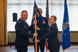 Lt. Col. Cara Treadwell assumes command of the Integrated Command, Control, Communications, Computers, Intelligence, Surveillance, and Reconnaissance Analysis Squadron after receiving the guidon from Col. John M. Minear, Networked Weapons and Modeling Intelligence Group commander, at Wright-Patterson Air Force Base, Ohio, June 29, 2026. The ceremony formally charges Treadwell with the leadership, welfare, and mission readiness of the squadron's personnel. (U.S. Air Force photo by Staff Sgt. Kristof J. Rixmann)