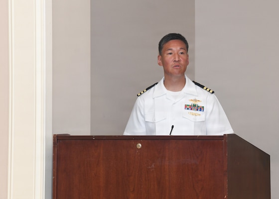 Family Medicine Residency Program Director Cmdr. Daniel Hwang speaks to graduates during the Naval Medical Center Camp Lejeune Family Medicine Residency and Sports Medicine Fellowship graduation ceremony on June 30, 2026. The program graduated 10 family medicine residents, 12 family medicine interns, and two sports medicine fellows for Navy Medicine.