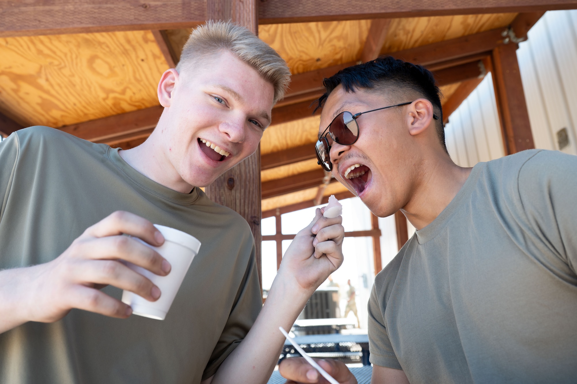 U.S. Air Force Airmen from the 55th Rescue Generation Squadron, pose for a photo with shaved ice provided by DM50, the Military Affairs Committee and the First Sergeants Council at Davis-Monthan Air Force Base, Arizona, July 2, 2026. The effort supported the well-being of Airmen working in high temperatures, reinforcing a culture of care and connectedness. (U.S. Air Force photo by Airman 1st Class Jaden Kidd)