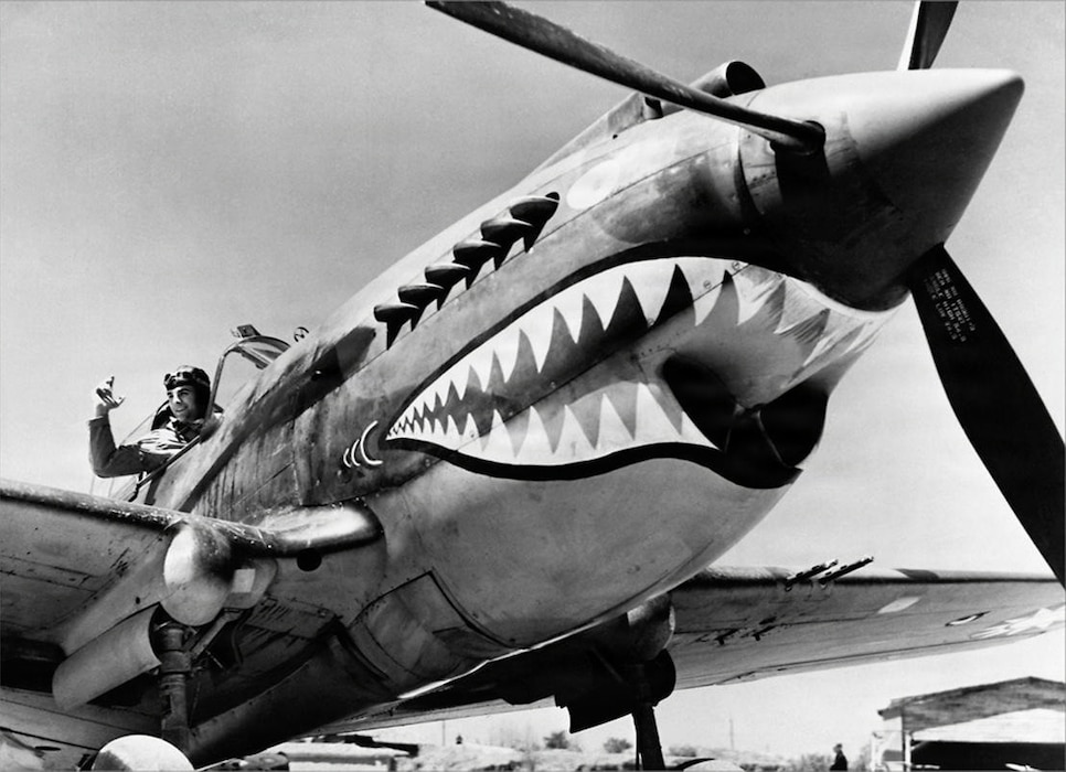 U.S. pilots assigned to the 23d Fighter Group pose with a Curtiss P-40 at the flightline in Kunming, China, July 1942.