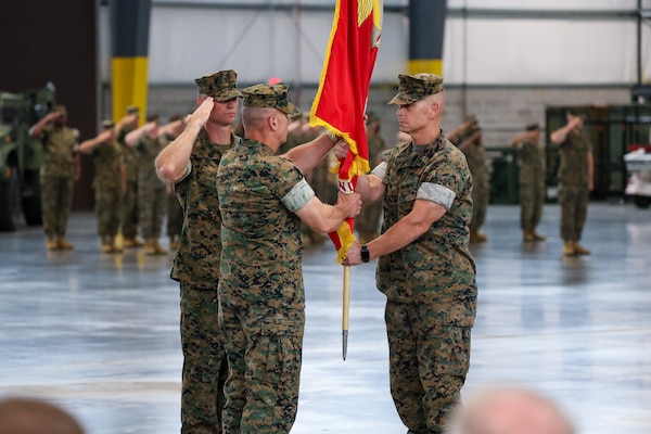 Brig. Gen. Kevin G. Collins accepts the Marine Corps Logistics Command organizational colors from Maj. Gen. Keith D. Reventlow during a change of command ceremony July 2, 2026, at Marine Corps Logistics Base Albany, Georgia. The passing of the colors symbolizes the transfer of authority, responsibility and accountability from Reventlow to Collins.