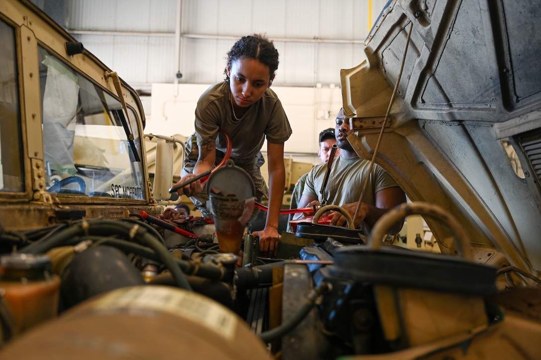 Soldier handles radiator of military truck. (U.S. Air Force photo by Airman 1st Class Donnell Ramsey)