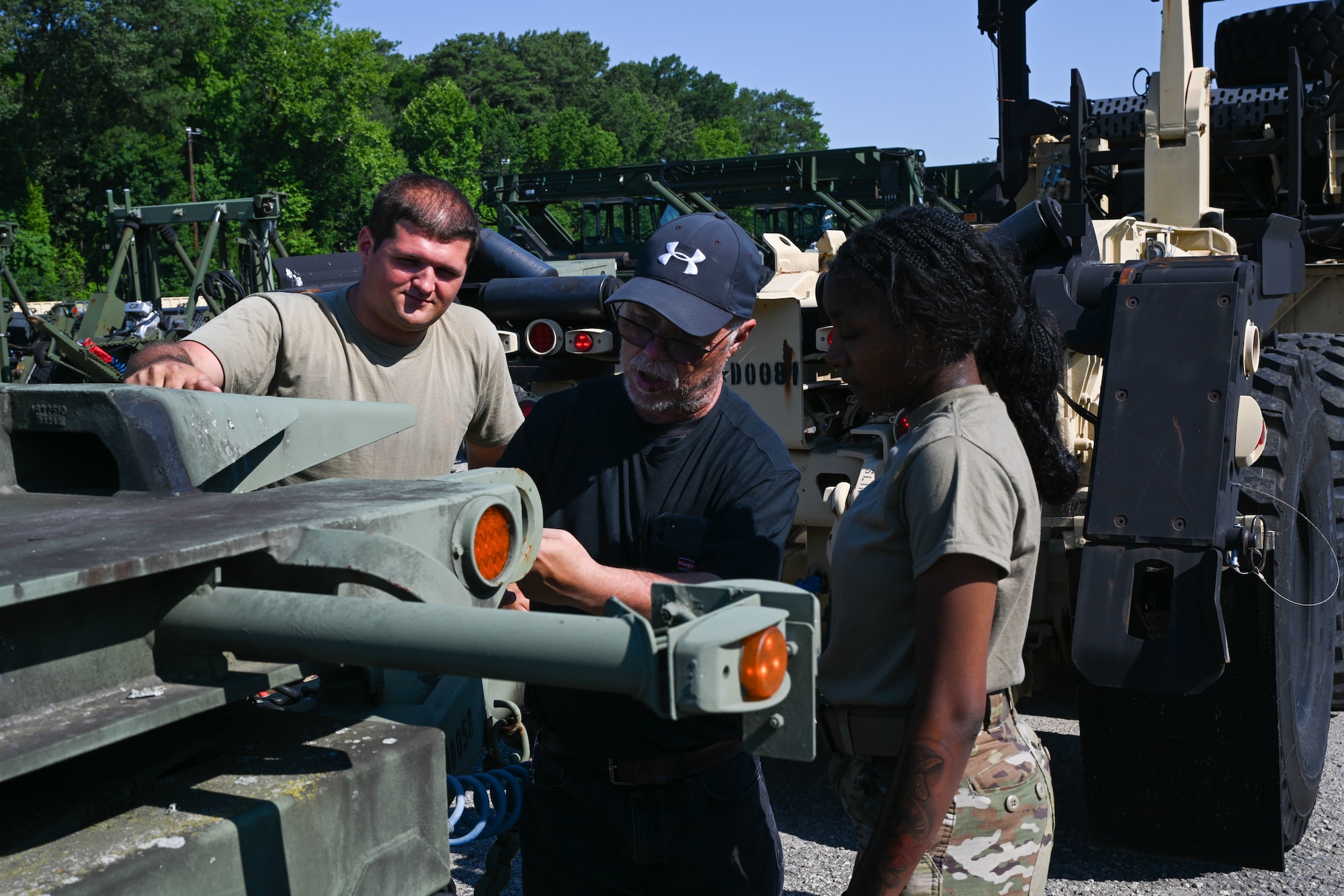 Civilian and Soldiers gather near the back of a truck. (U.S. Air Force photo by Airman 1st Class Donnell Ramsey)