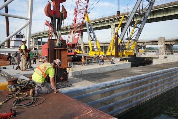 McKinney Salvage LLC, a subcontractor for CJ Mahan Construction Co., operates a heavy-lift derrick crane to guide a 420-ton concrete beam into position for the Chickamauga Lock Replacement Project's upstream approach wall Tuesday, June 16, 2026, on the Tennessee River. The placement marks the first of eight beams installed during this phase of construction for the U.S. Army Corps of Engineers Nashville District, demonstrating the critical engineering partnerships driving forward USACE’s mission to modernize regional waterways and deliver resilient navigation infrastructure for the nation. (USACE Photo by Noe Gonzalez)