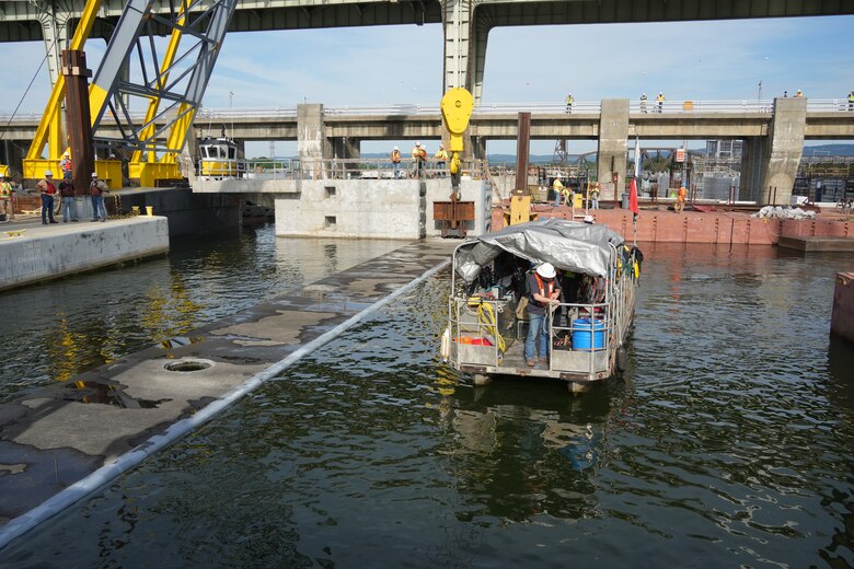 A specialized dive team stands ready on the Tennessee River during the placement of a 420-ton concrete beam for the Chickamauga Lock Replacement Project's upstream approach wall, June 16, 2026, in Chattanooga, Tenn. Once a beam is lowered, the divers perform critical underwater inspections to verify it is perfectly seated on its bearing pads. This meticulous quality assurance is vital to the U.S. Army Corps of Engineers' mission of delivering safe, modern, and resilient navigation infrastructure for the nation. (USACE Photo by Noe Gonzalez)
