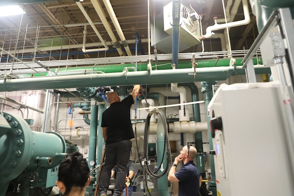 Practicum instructor Brian Clark (right), research mechanical engineer at the U.S. Army Engineer Research and Development Center’s Construction Engineer Research Laboratory (ERDC-CERL), observes students’ interactions with the equipment in the ERDC-CERL Central Utility Plant.