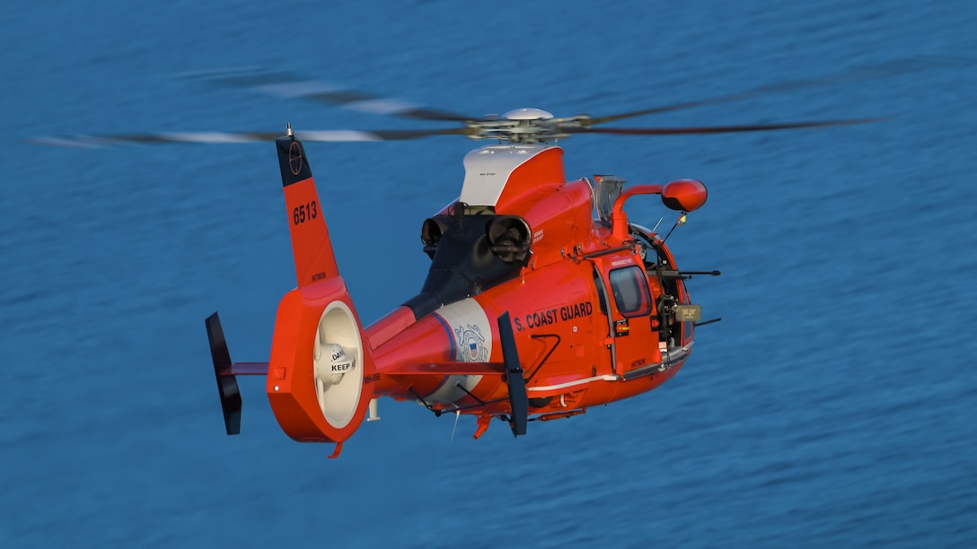 An MH-65E Dolphin helicopter from the Coast Guard Helicopter Interdiction Tactical Squadron with new "Blackfin" paint design conducts airborne-use-of-force training in the Caribbean Sea, Apr. 21, 2026. The HITRON aviation detachment was embarked aboard Coast Guard Cutter Bear (WMEC 901) and assisted in disabling drug smuggling vessels as part of Operation Pacific Viper; the new “Blackfin” on the helicopter's rudder commemorated HITRON’s most successful fiscal year on record, and the milestone of surpassing 1,000 interdictions. (U.S. Coast Guard photo)