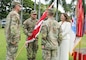 Three male Army Soldiers and one woman standing facing each other for a ceremony