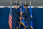 Lt. Gen. Clark Quinn, Air Education and Training Command commander passes the guidon to Brig. Gen. Travolis Simmons, as he takes command of Nineteenth Air Force July 2, 2026, at Joint Base San Antonio-Randolph. (U.S. Air Force photo by Benjamin Faske)