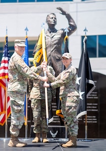 U.S. Space Force Lt. Gen. Philip Garrant, commander of Space Systems Command, presents the System Delta 88 guidon to Col. Ryan Rose, incoming commander of System Delta 88, during a change of command ceremony at Los Angeles Air Force Base in El Segundo, California, June 26, 2026. The transfer of the guidon symbolizes the formal assumption of command. System Delta 88 supports Space Systems Command’s delivery of satellites, ground control segments, data systems, and software capabilities for asymmetric, all-domain SATCOM superiority. (U.S. Space Force photo by Van Ha)