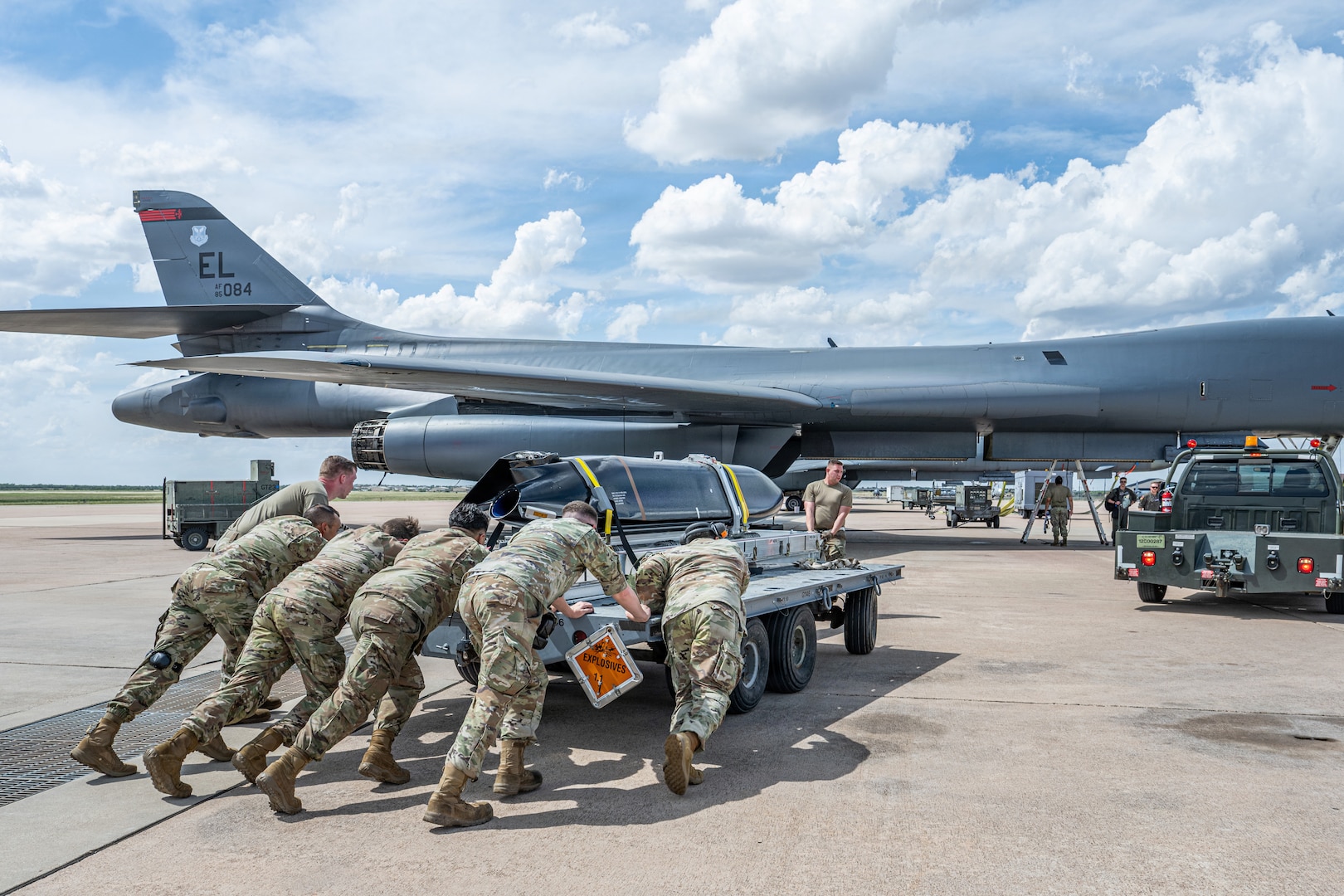 Airmen work on the flightline next to a B-1B Lancer