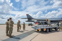 Airmen work on the flightline next to a B-1B Lancer