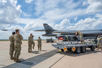Airmen work on the flightline next to a B-1B Lancer
