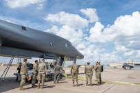Airmen work on the flightline next to a B-1B Lancer